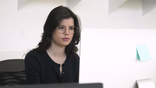 Businesswoman in Eyeglasses Working at Computer in Office 2529 Years