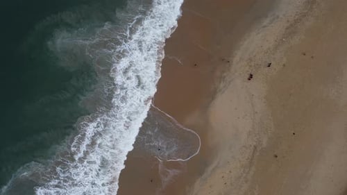 Aerial drone shot of turquoise sea water at the beach. Top view of beautiful arabian sea.
