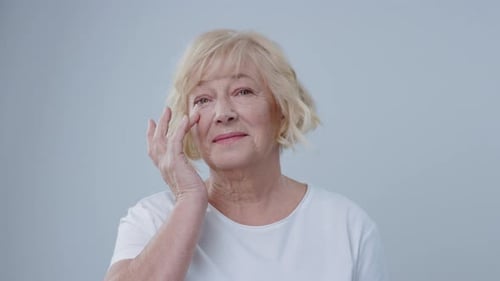 Senior Woman's Radiant Skincare Routine in Close-up