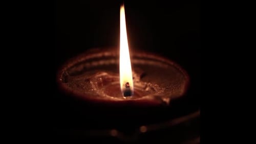 Flickering Diya Lamp in Dark Setting Close Up