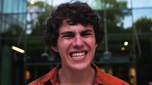 Man Yelling in Front of a Modern Building
