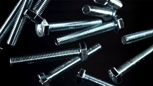Close Up of Silver Bolts on Black Surface