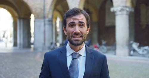 Man in Suit Talking Outdoors in Urban Location