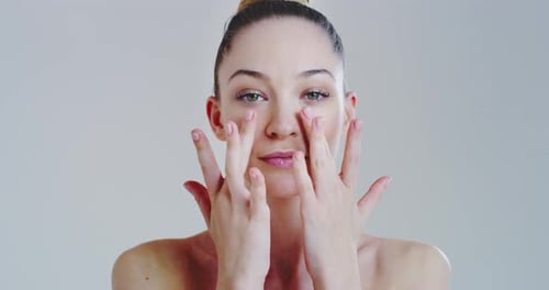 Slow motion of woman with beautiful face and perfect skin just cleaned from impurities pampering i