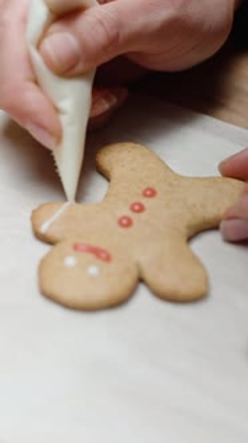 Vertical video. Homemade gingerbread cookies in the shape of little people for Christmas