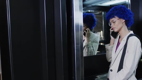 Stylish Woman Talking on Phone Inside Elevator
