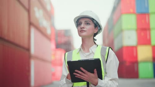 Professional female logistics supervisor in a hard hat