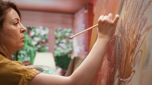 Female Painter Working on a Canvas to Create an Artwork in Studio
