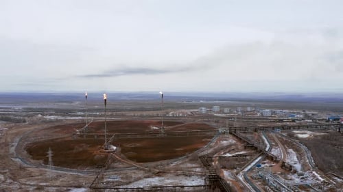 A burning high-altitude torches at a gas production and processing plant.