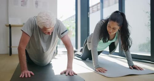 4k video footage of a senior patient practicing yoga with his physiotherapist in her clinic