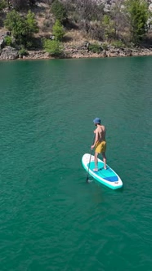 Vertical Video Scenic Paddleboarding Journey With Friends Through a Beautiful Green Canyon