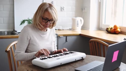 Woman Plays Electronic Keyboard at Home