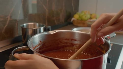 Stirring Sauce in a Kitchen Pot