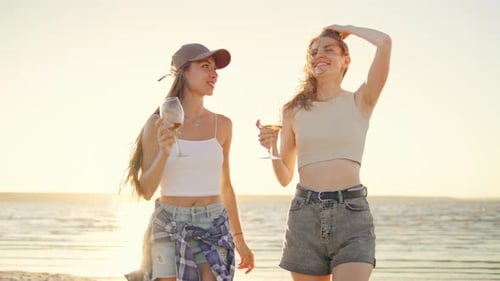 Two Good Friends Enjoying a Beautiful and Serene Sunset Walk Together on the Beach Embracing the