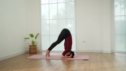 Woman Demonstrating Headstand Yoga Pose Indoors