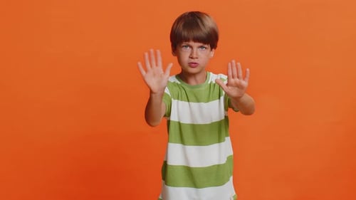 Child Boy Say No Hold Palm Folded Crossed Hands in Stop Gesture Warning of Finish Prohibited Access
