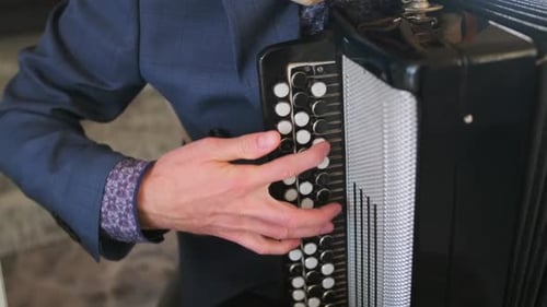 Close up view of accordion in hands of man indoors