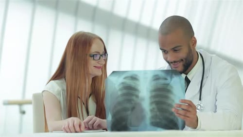 Doctor Explains X-ray to Patient in Modern Hospital