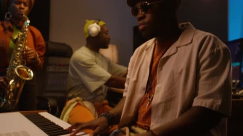 Three Black Musicians Recording Instrumental Music in Studio