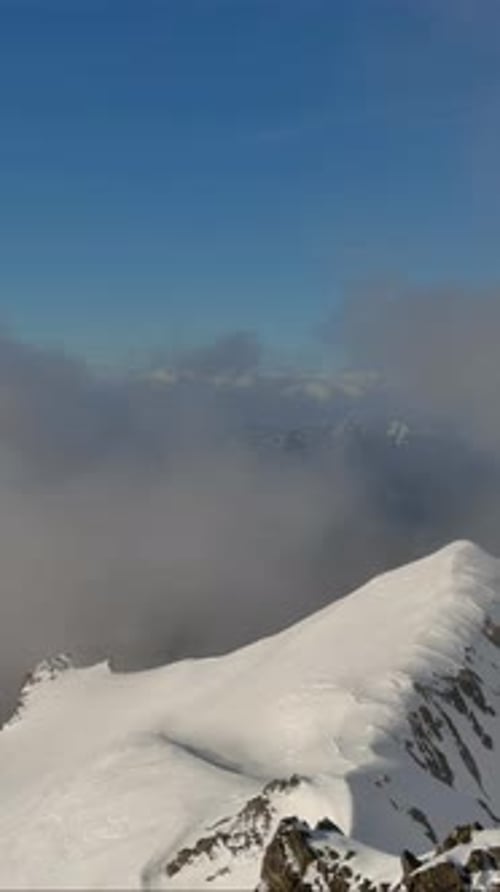 Snowy Mountain Peaks Above The Clouds. British Columbia, Canada.