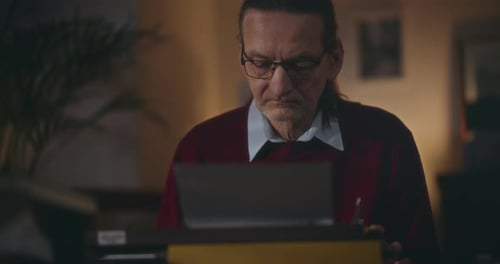 Man Typing on a Typewriter Indoors