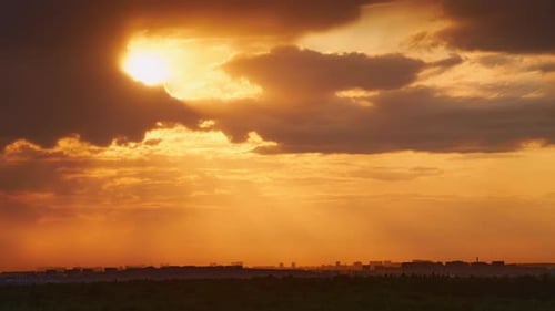 The red sky at sunset contrasts beautifully with the green nature around it, time lapse