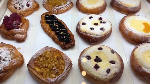 Freshly Baked Puff Pastry Desserts in a Cafe Shop Display Slow Motion Closeup