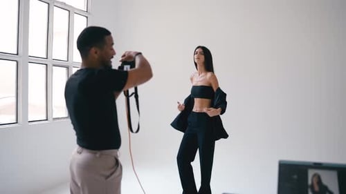 Professional Photographer Taking Pictures of Fashion Model in Studio