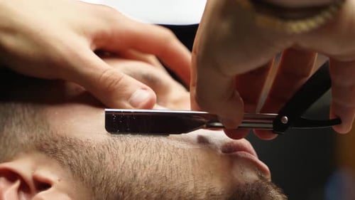 Man Receives Straight Razor Shave at Barbershop
