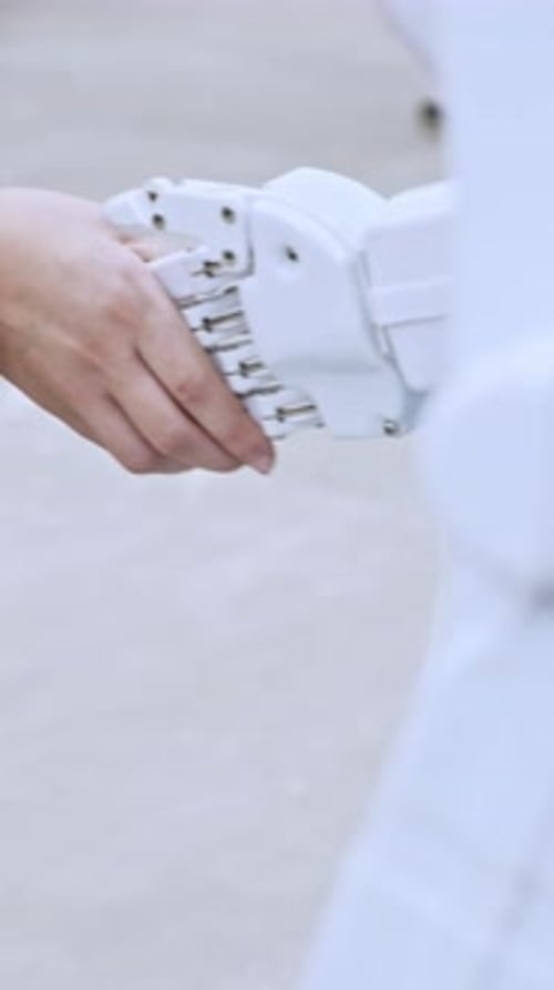 Hand interacts with a robotic hand close up