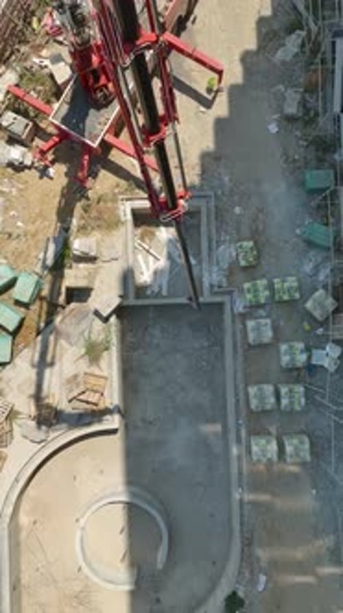 Vertical Video Aerial View Loading Cargo to Upper Floors at a Construction Site