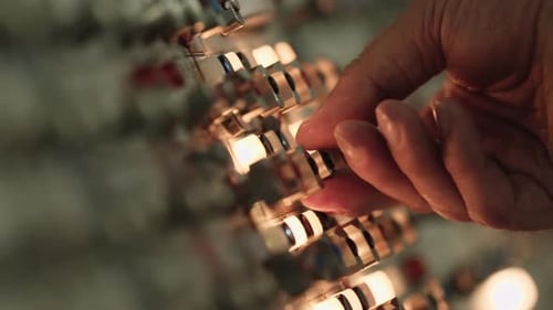 Hand works on a control panel.