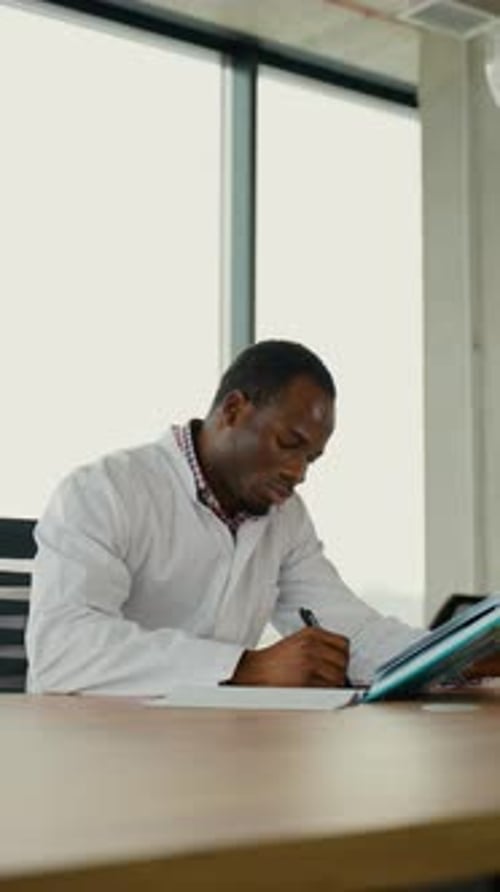 Black Guy Nursing Student Intern is Preparing for the Exam Vertical Video