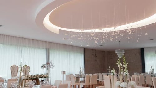 elegant wedding reception hall with modern lighting and refined table decor
