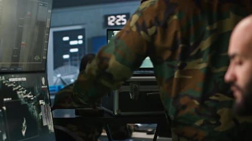 Men in Command Center Monitor Drone Footage