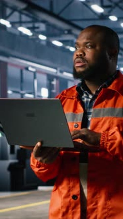 Vertical Video Industrial Staff Member Oversees Assembly Work in a Warehouse