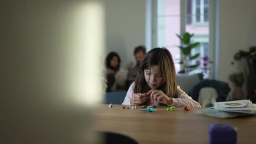Candid scene of little Focused Child in Toy Assembly, Engrossed Little Girl Playing with toys. Kid