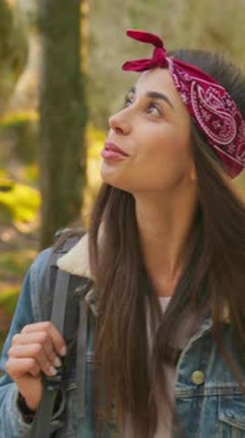 A Young Woman Embarking on an Exciting Hike in Nature While Wearing a Colorful Bandana
