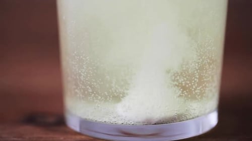 Effervescent tablet dissolving in a glass of water