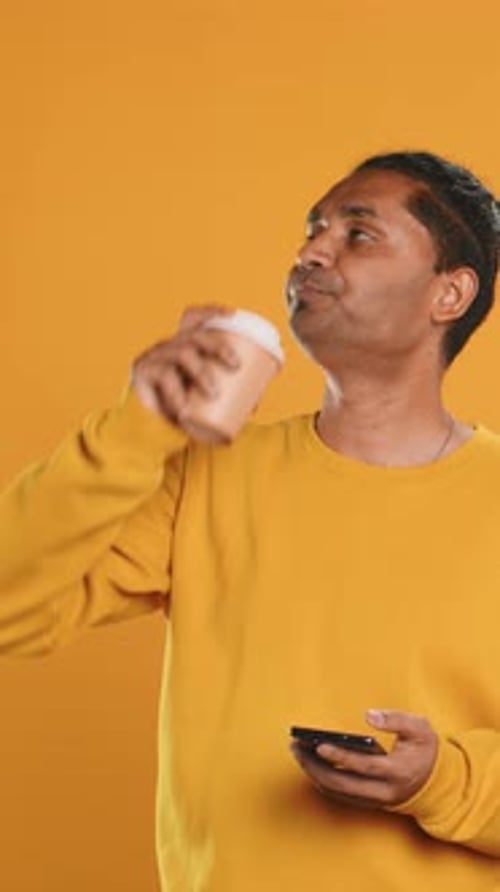 Man Enjoying Fresh Coffee From Disposable Paper Cup Studio Background