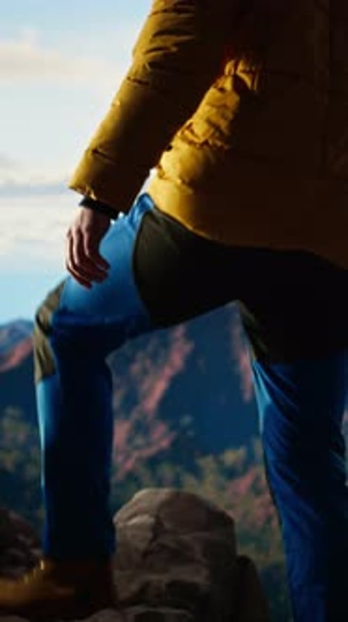Vertical Video Alone Traveler Stands on a Mountain Summit Soaking in the Stunning View of Peaks