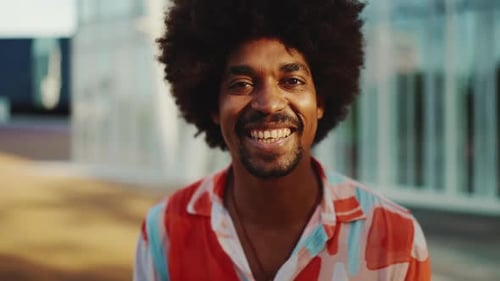 portrait of Smiling man wearing shirt standing on an urban street background