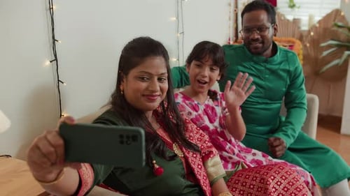 Indian Parents and Daughter Calling on Video on Phone during Diwali Celebration
