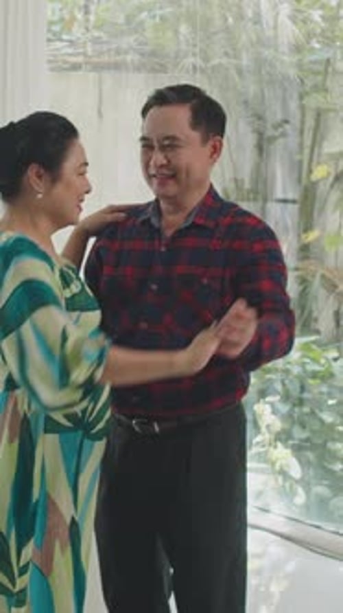 Mature Asian Spouses Having Romantic Dance at Home