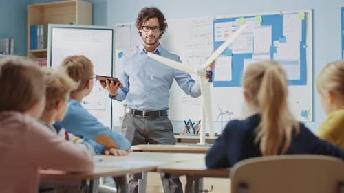 Elementary School Physics Teacher Uses Interactive Digital Tablet to Show to a Classroom of Smart C