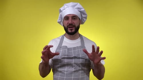Friendly Chef Explaining, Standing on Yellow Backdrop