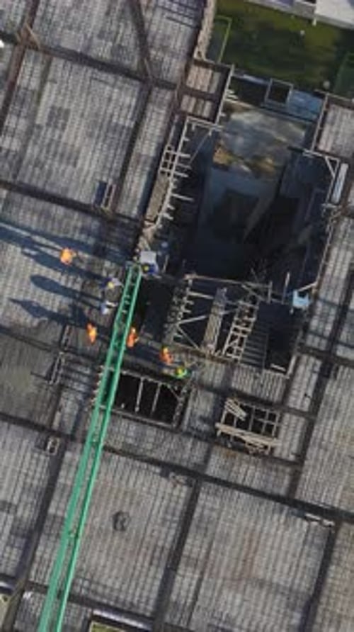 Vertical Video of Workers Installing Metal Frames and Building Walls at a Residential Construction
