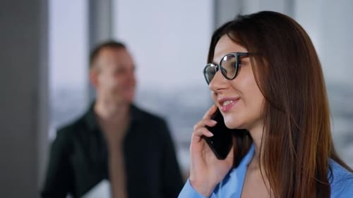 Woman Talking on Phone in Modern Office Setting