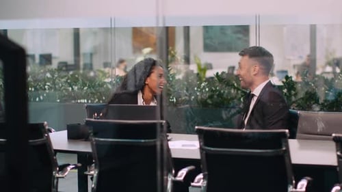 Professionals Engage in Lively Discussion at Corporate Office During Work Hours