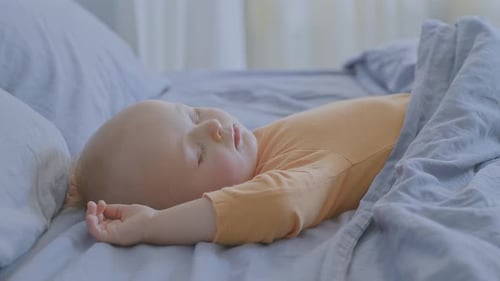 Blond Infant Sleeping Peacefully on Bed